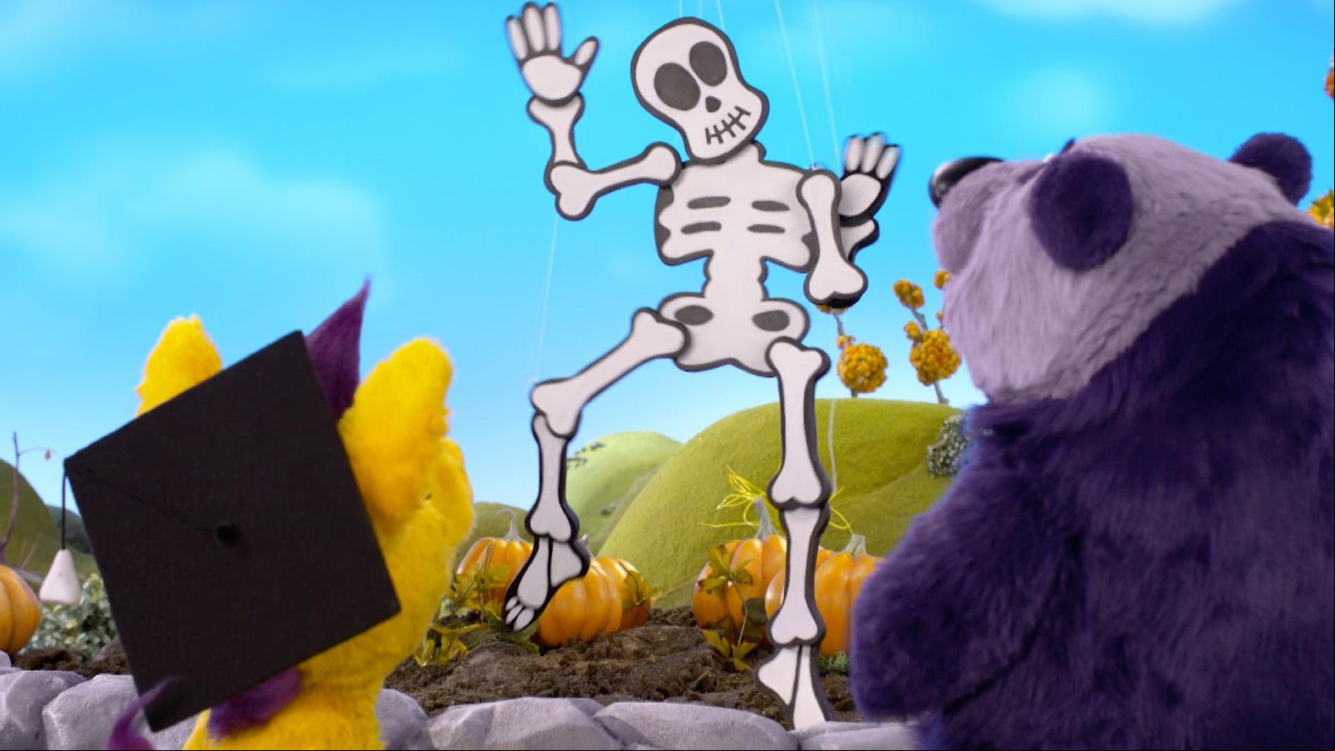 Donkey shows Panda how penguin puppeteers make a skeleton decoration dance.