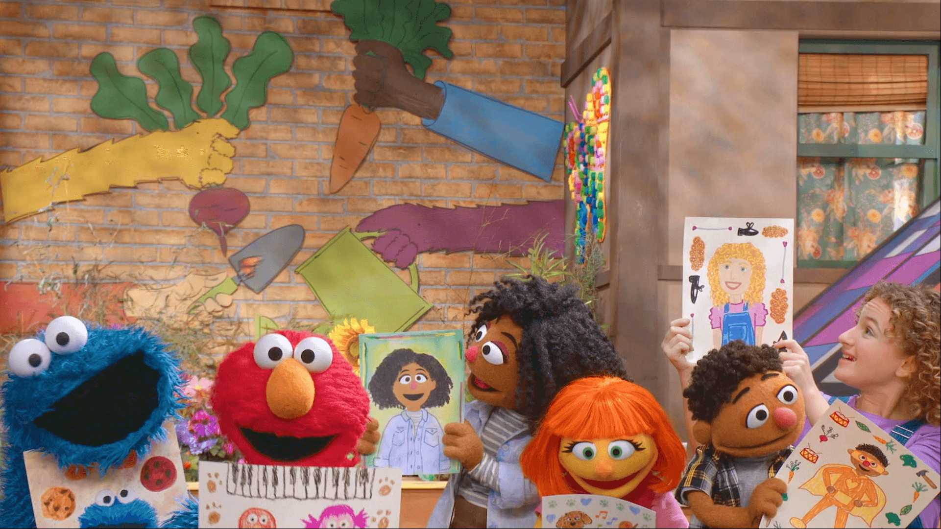 Elmo, Tamir, Charlie, Julia, and Cookie Monster are making self-portraits.