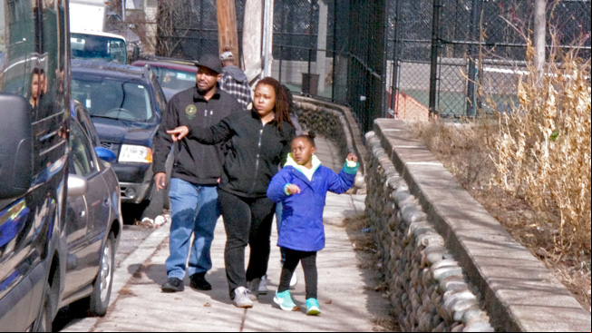 Family points at cars